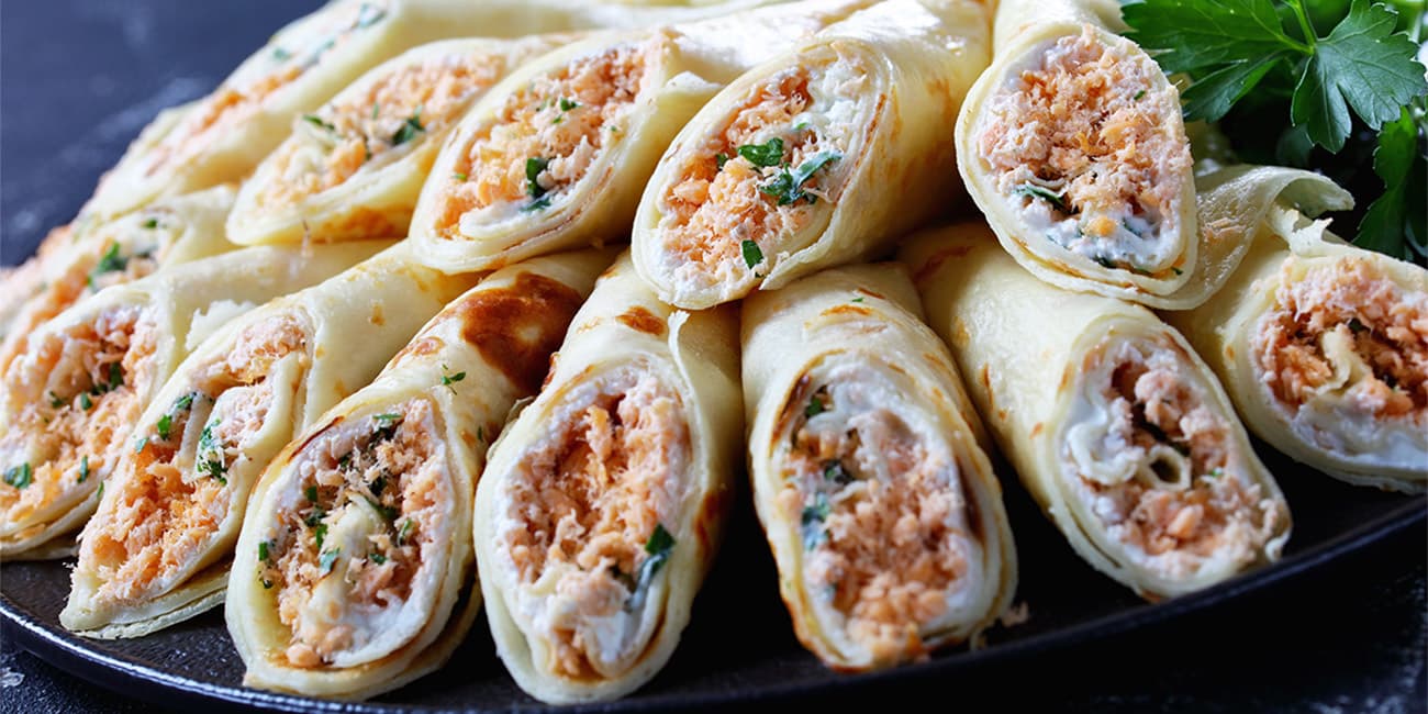 Thin crepes with cream cheese and shredded salmon